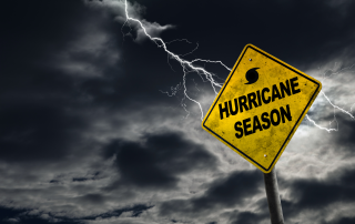 Hurricane season warning sign against dark stormy sky with lightning, emphasizing the risks of property damage and the need for legal assistance after hurricanes in Florida.
