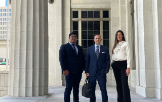 Civil law attorneys standing outside a courthouse, representing Perkins Law Offices, showcasing their commitment to client advocacy in personal injury cases.