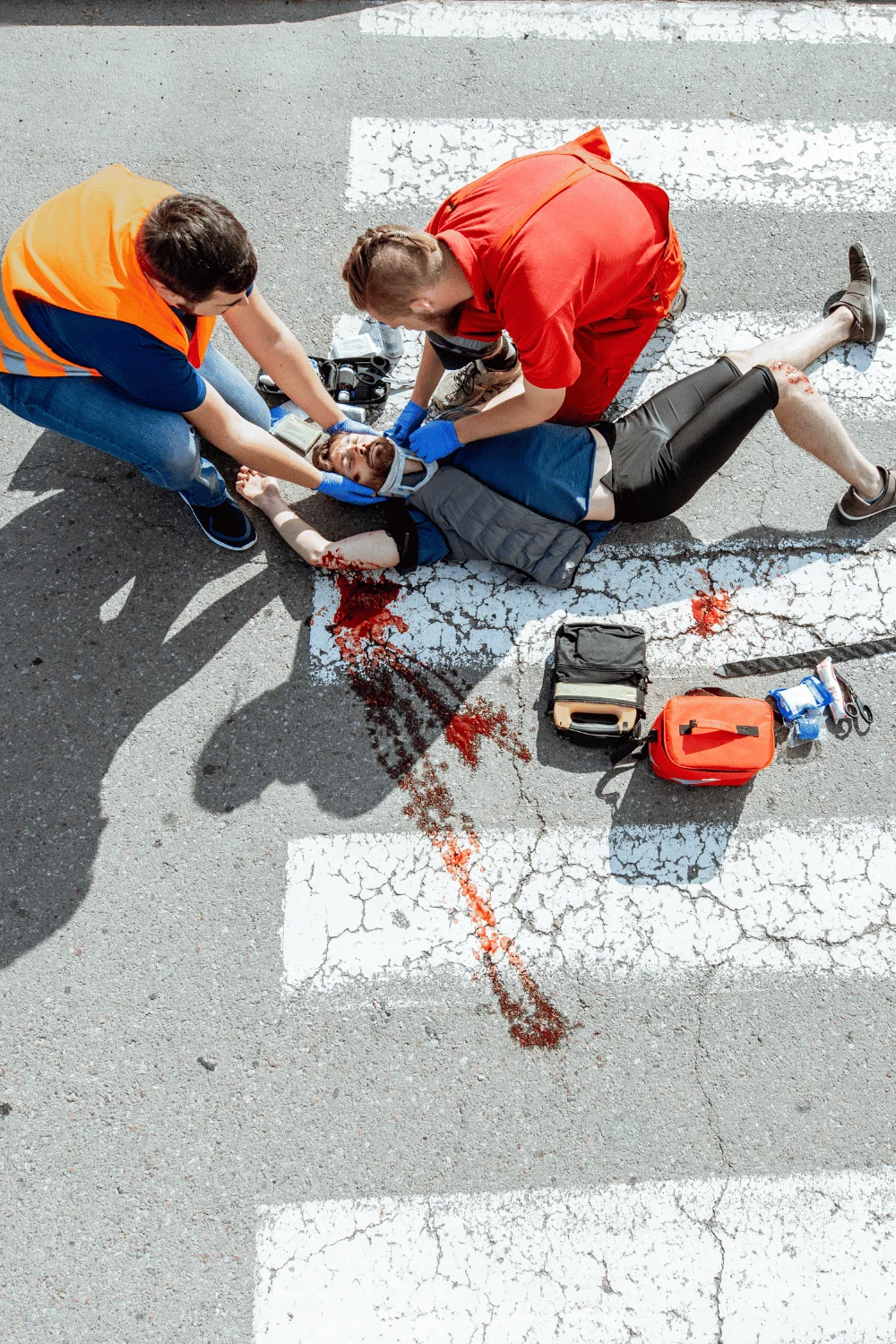 free consultation with a personal injury lawyer, of a biker who has been injured on a road with two people helping him